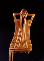 Comb in the shape of a stylized female figure with incised decorations.