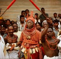 The late Oba Akenzua II in full regalia, including a coral garment and headpiece.