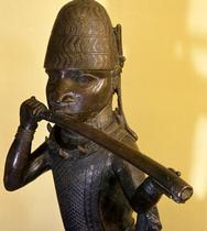 A figure of a hornblower or trumpeter such as would have been part of the retinue of important chiefs and warriors at the Benin court.