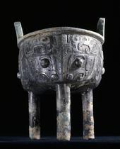 Archaic ding vessel decorated with large taotie masks.